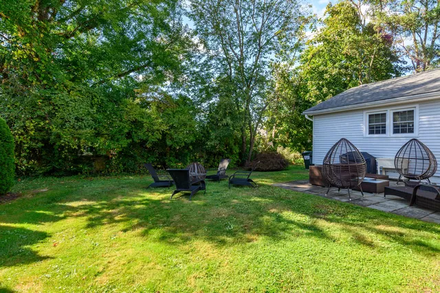 a view of a house with backyard and sitting area