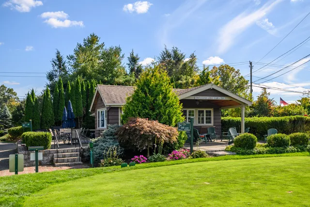 a view of a house with a yard and sitting area