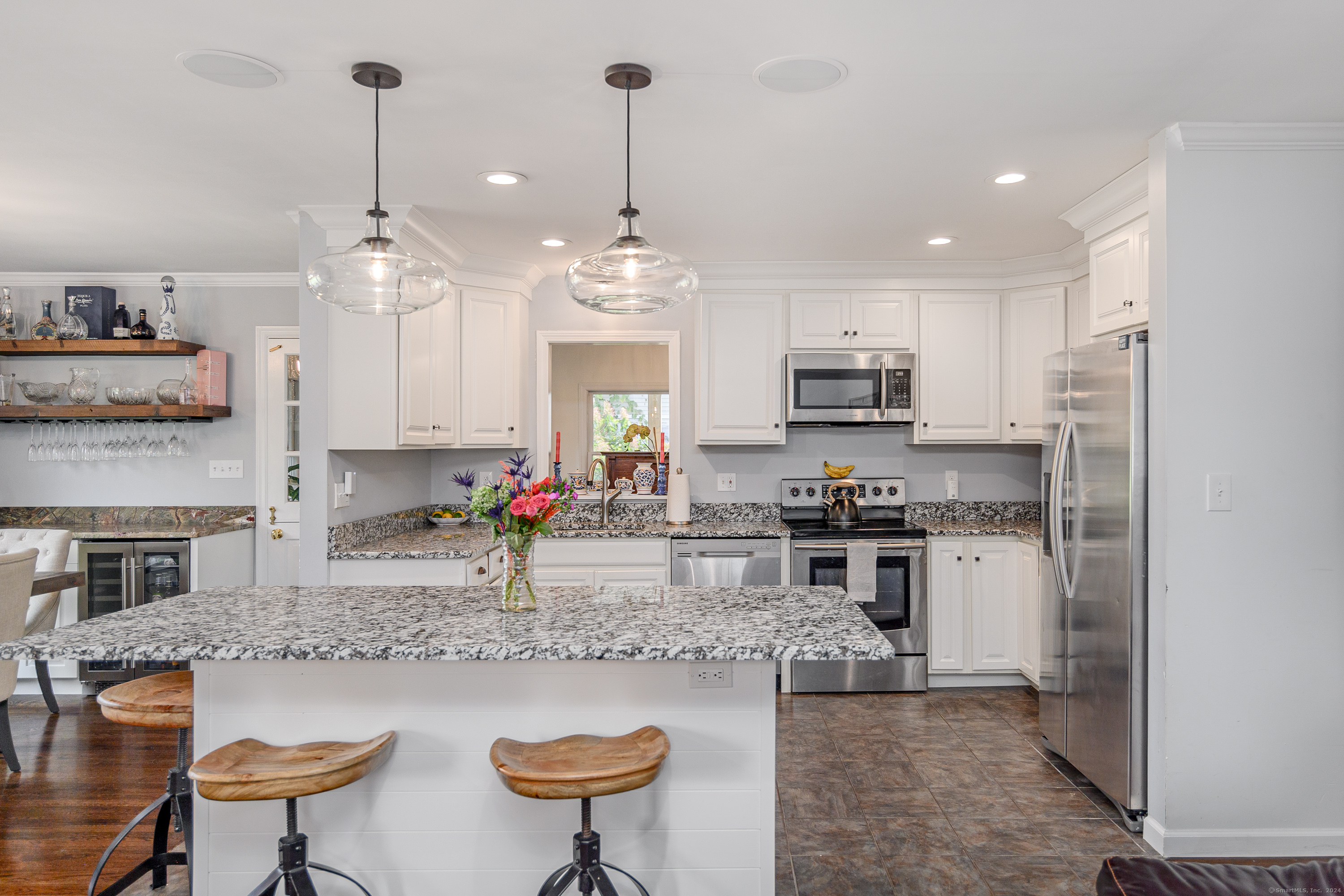 22 Brookside Trail New Milford, CT 06776 - Photo 7 of 40 a kitchen with stainless steel appliances granite countertop a stove top oven a sink a dining table and chairs