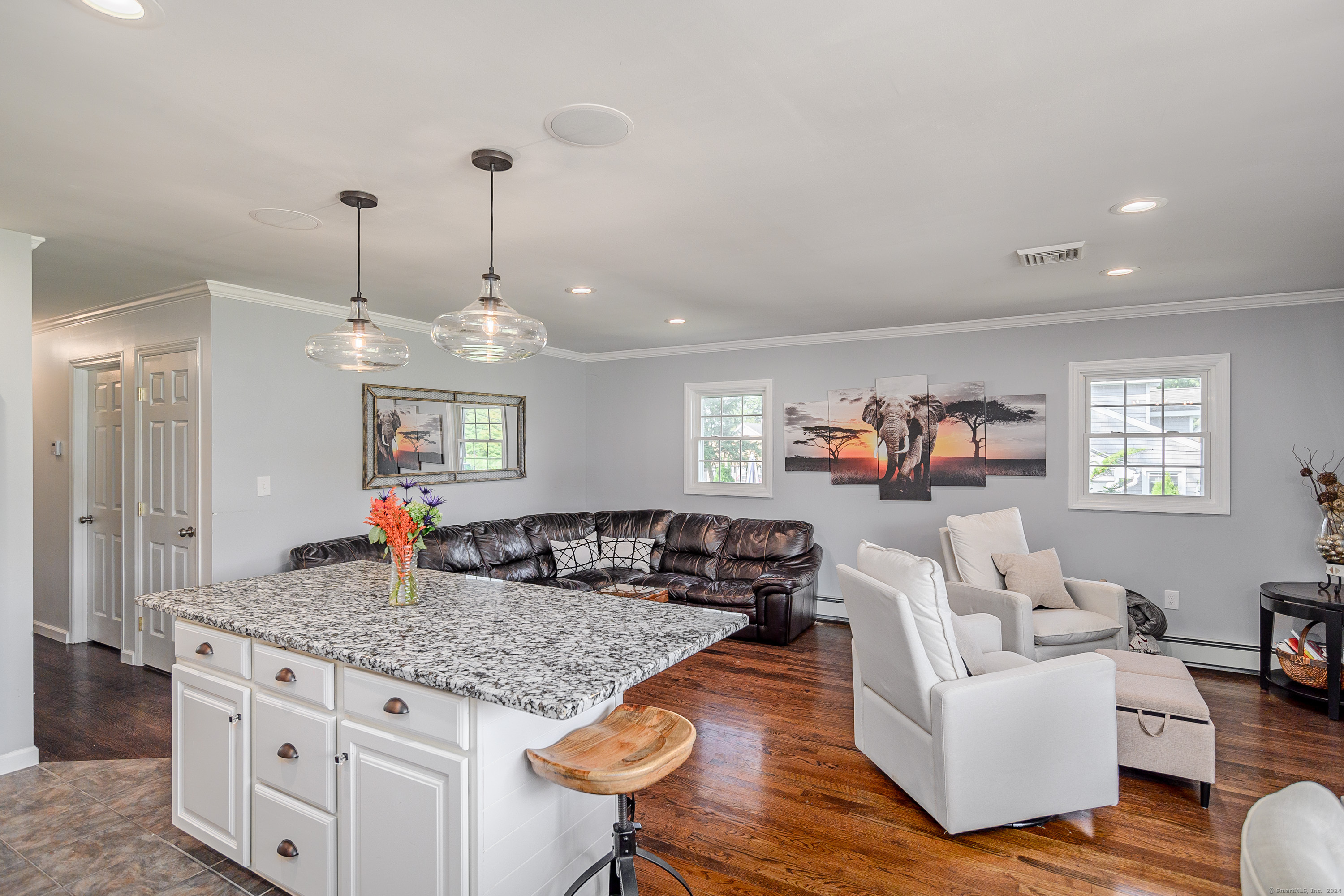 22 Brookside Trail New Milford, CT 06776 - Photo 8 of 40 a living room with furniture kitchen view and a chandelier