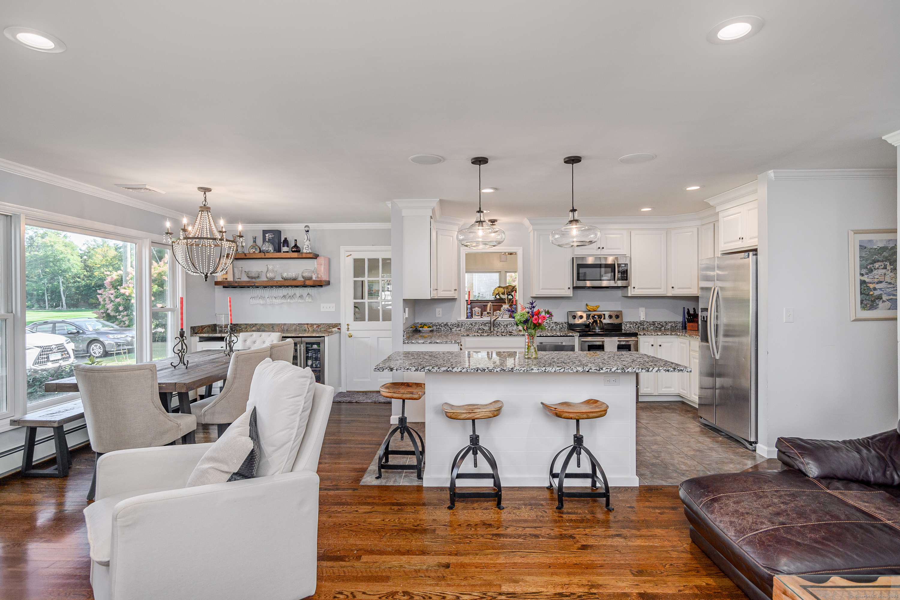 22 Brookside Trail New Milford, CT 06776 - Photo 9 of 40 a living room with stainless steel appliances kitchen island granite countertop a dining table chairs and a refrigerator
