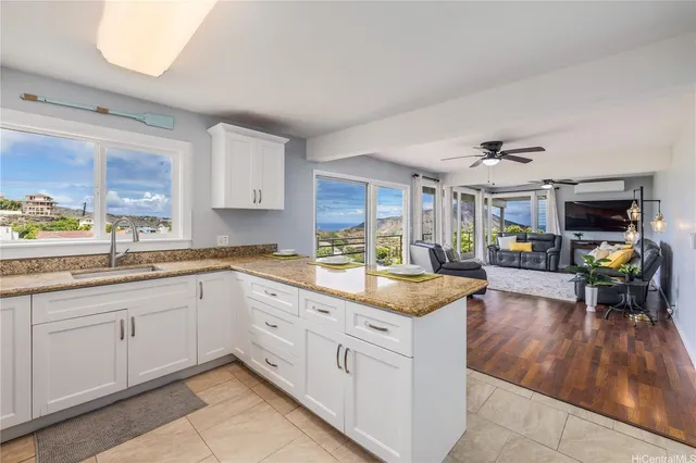 a large kitchen with a lot of counter space and wooden floor
