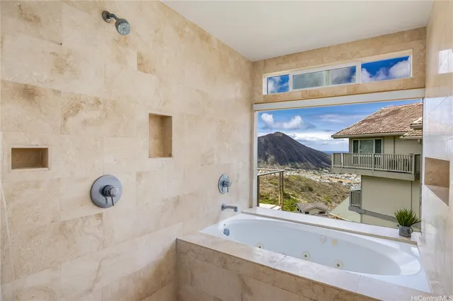a bathroom with a tub and shower