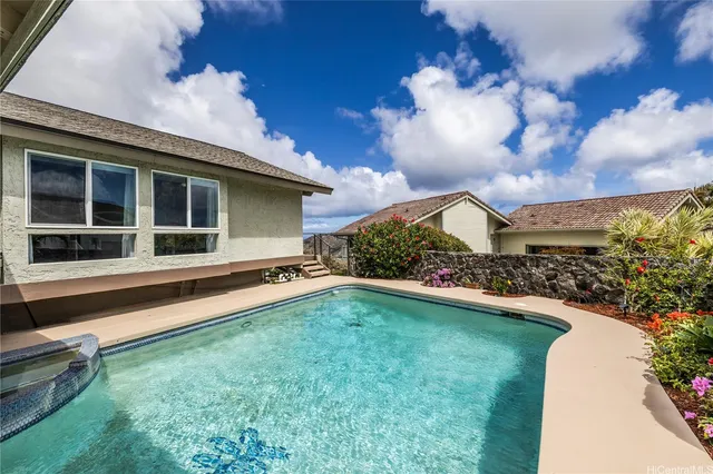a view of a house with a big yard and a large tree