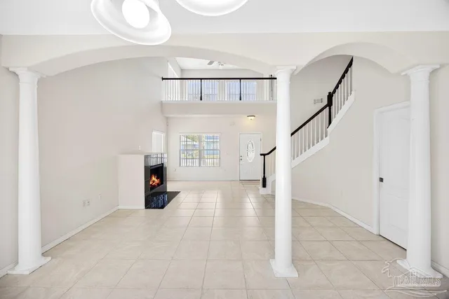 a view of empty room with fireplace and fan