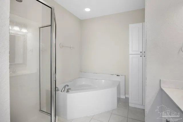 a bathroom with a double vanity sink mirror and shower