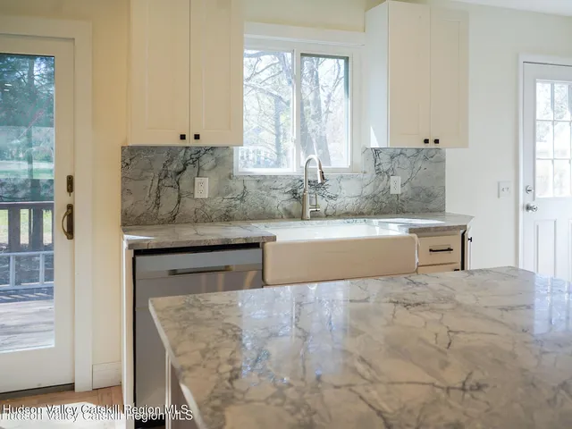 a bedroom with a bed next to a window