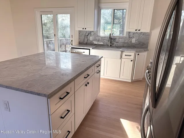 an aerial view of a house with a yard and lake view