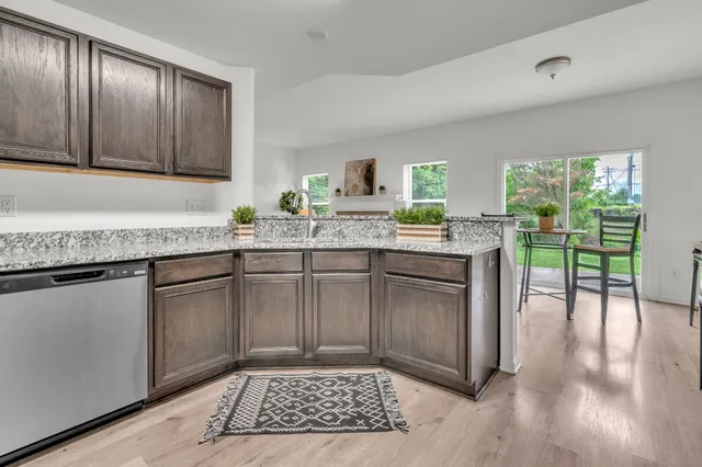 a kitchen with granite countertop a sink and cabinets