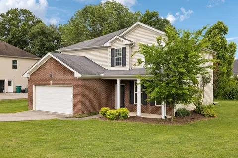 a view of a field of grass and trees