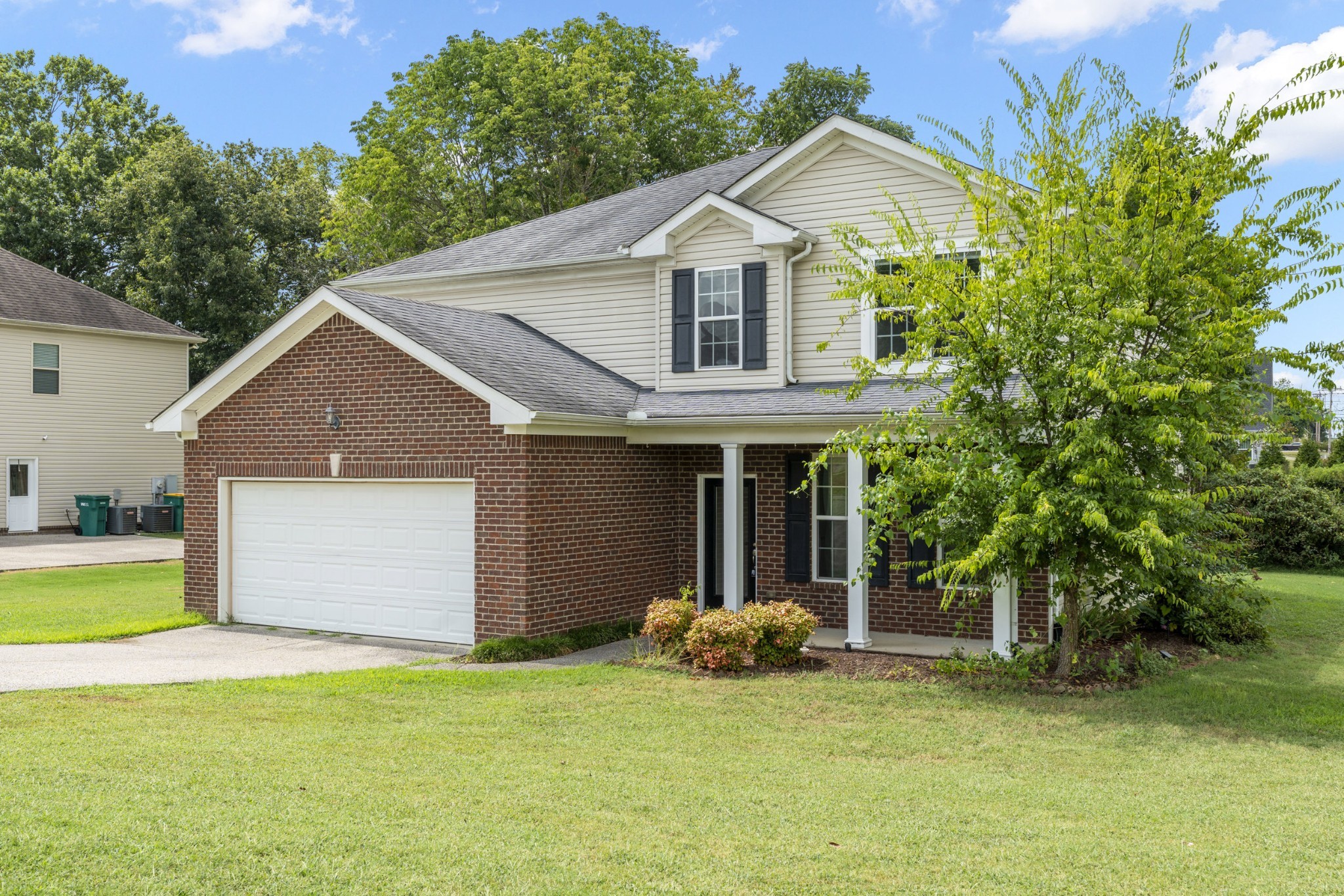 1000 Beverly Lane Spring Hill, TN 37174 - Photo 44 of 54 a front view of a house with a garden and trees