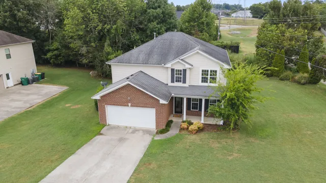 a front view of a house with a yard and garage