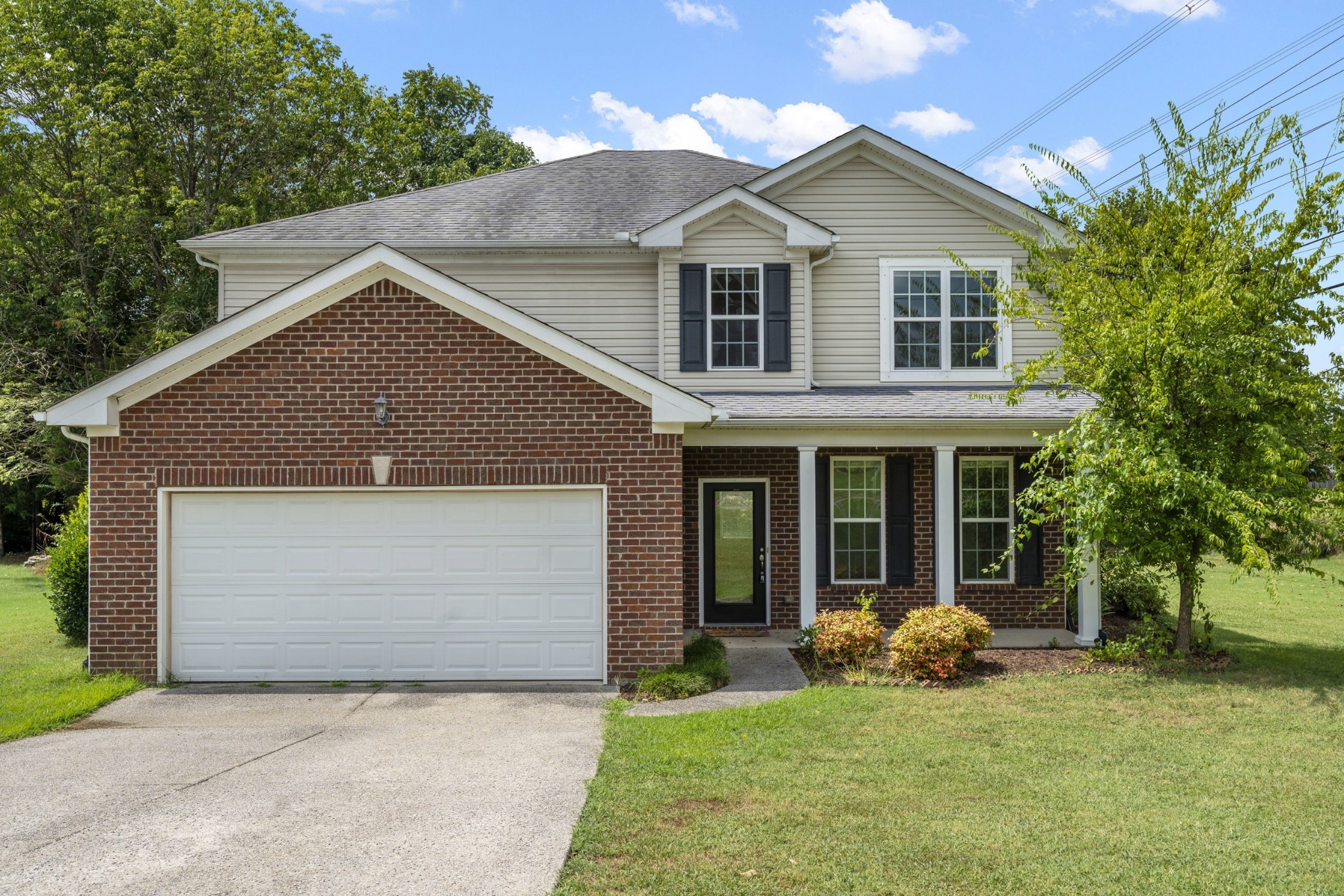 1000 Beverly Lane Spring Hill, TN 37174 - Photo 50 of 54 a front view of a house with a yard and garage