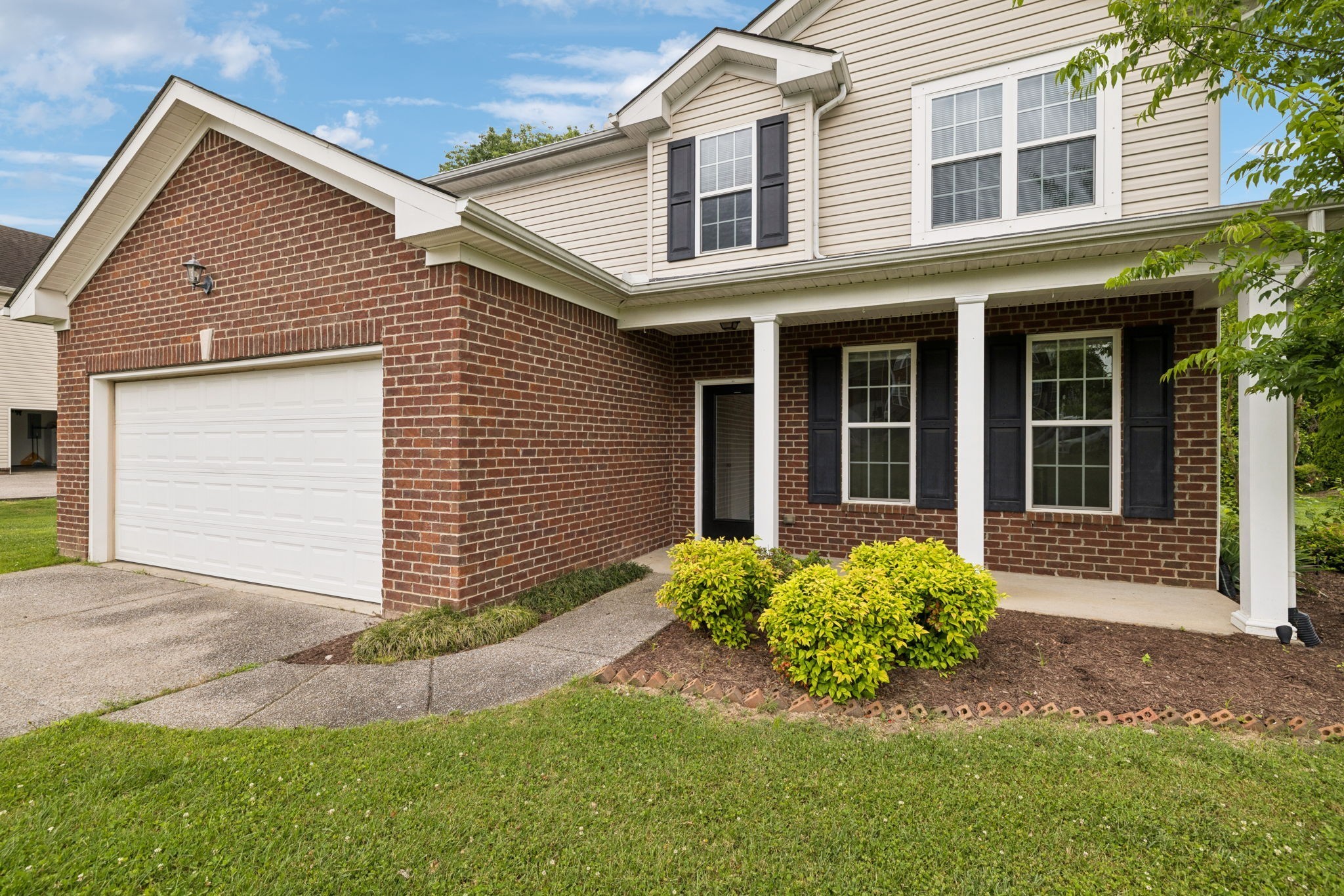 1000 Beverly Lane Spring Hill, TN 37174 - Photo 6 of 54 a front view of a house with a garden and yard