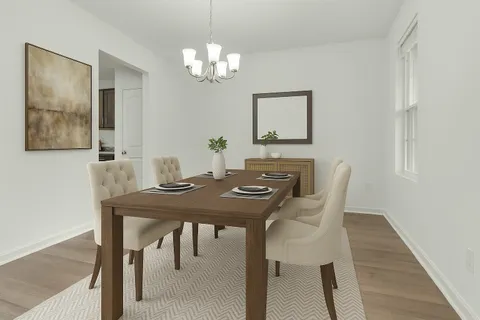 a view of a dining room with furniture and chandelier