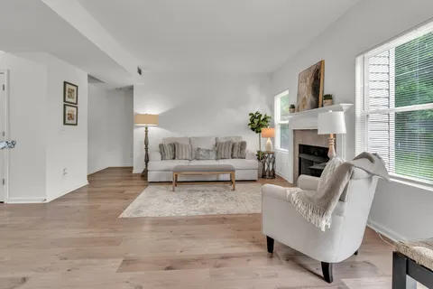 a living room with furniture and a fireplace