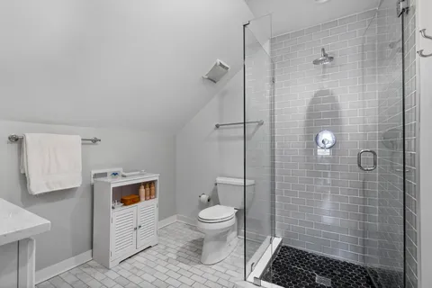 a bathroom with a toilet and a shower