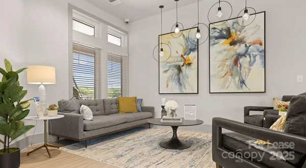 a living room with furniture and a chandelier