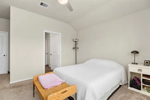 a bedroom with a bed and a table