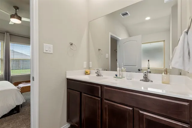a bathroom with a sink double vanity and a mirror