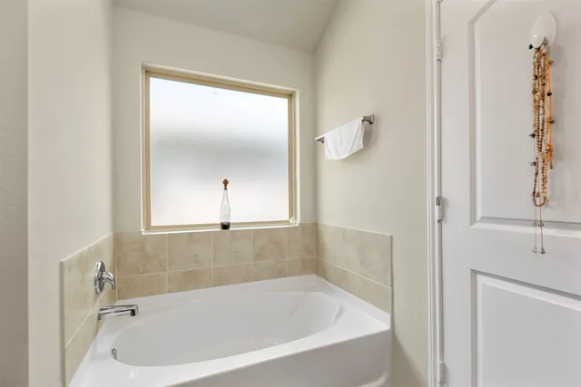 a white bath tub sitting next to a shower