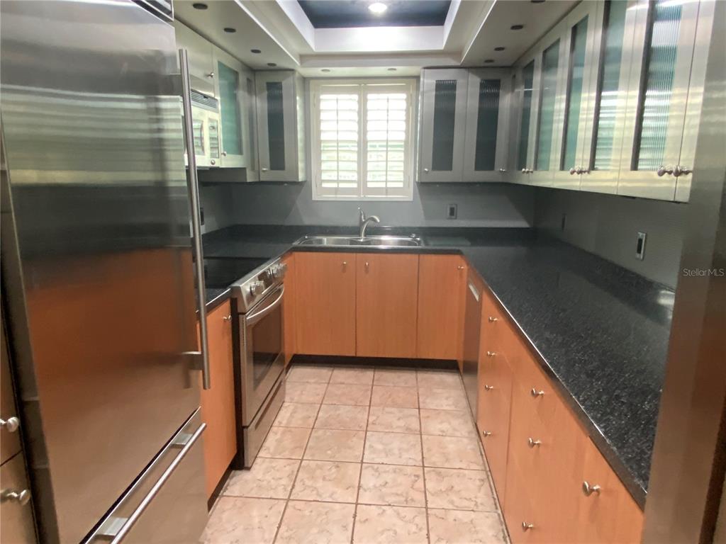 1500 Gay Road, Unit 17D Winter Park, FL 32789 - Photo 14 of 34 a kitchen with stainless steel appliances granite countertop a sink and a stove