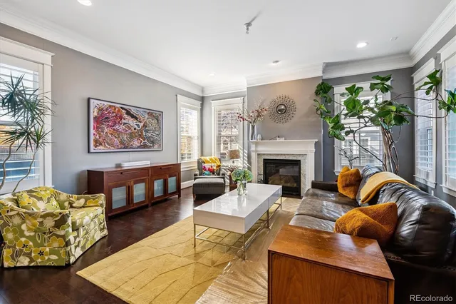 a living room with furniture large window and a fireplace
