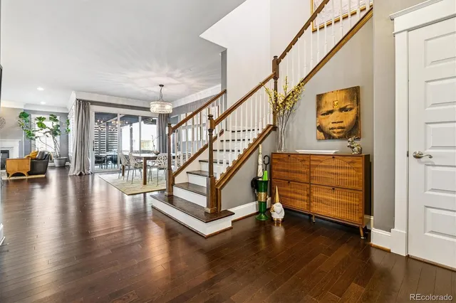 a view of a dining room with furniture wooden floor and a chandelier