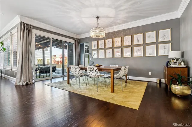 a kitchen with stainless steel appliances kitchen island granite countertop a table chairs sink and cabinets