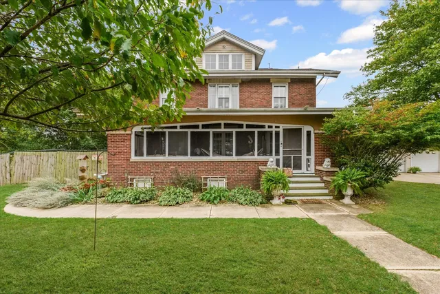 a front view of a house with a garden and yard