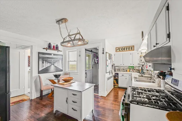 a kitchen with stainless steel appliances a stove a sink and a refrigerator