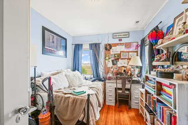 a bedroom with furniture and a book shelf