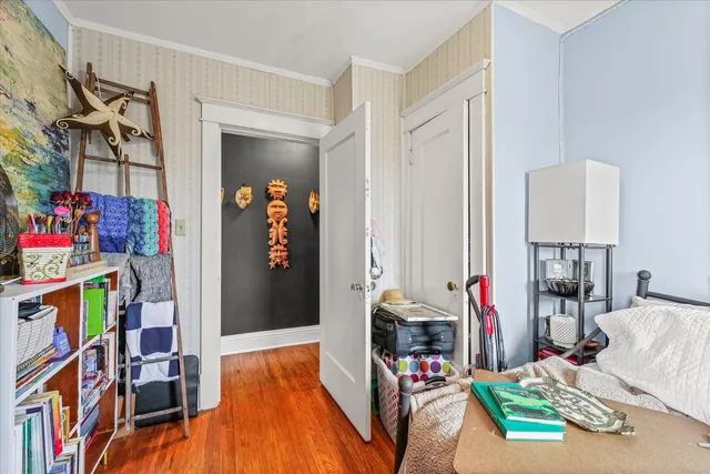 a bedroom with furniture and a book shelf