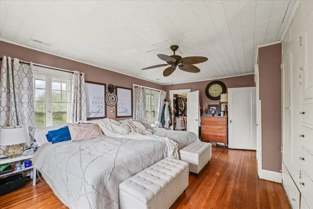 a bedroom with a large bed and a large window
