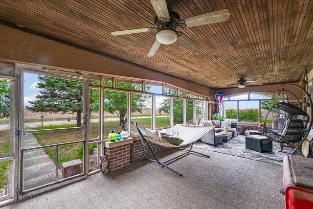 a living room with furniture and a floor to ceiling window