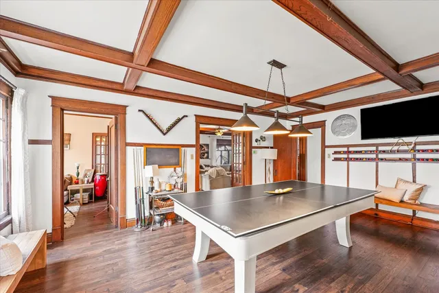 a living room with furniture a flat screen tv and floor to ceiling window