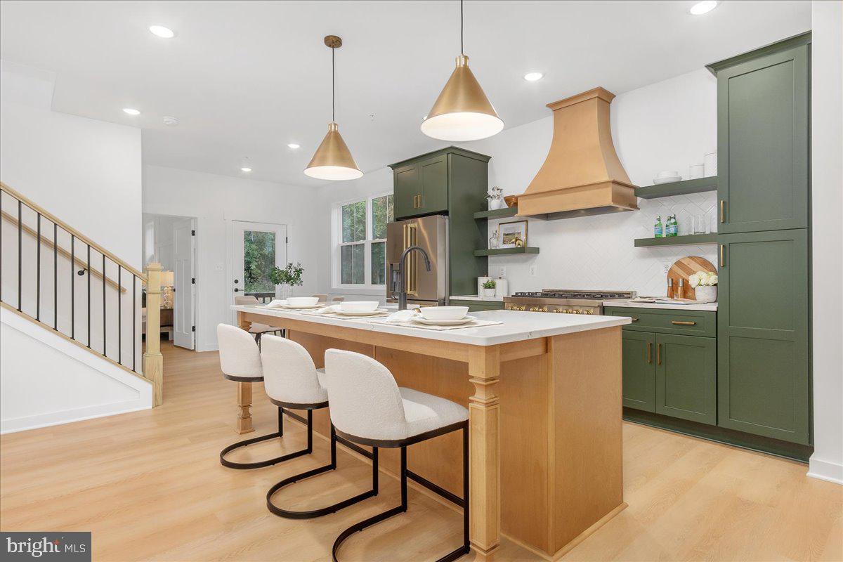 14 Stouffer Avenue Boonsboro, MD 21713 - Photo 12 of 40 a kitchen with stainless steel appliances granite countertop a sink a stove a refrigerator and island with wooden floor