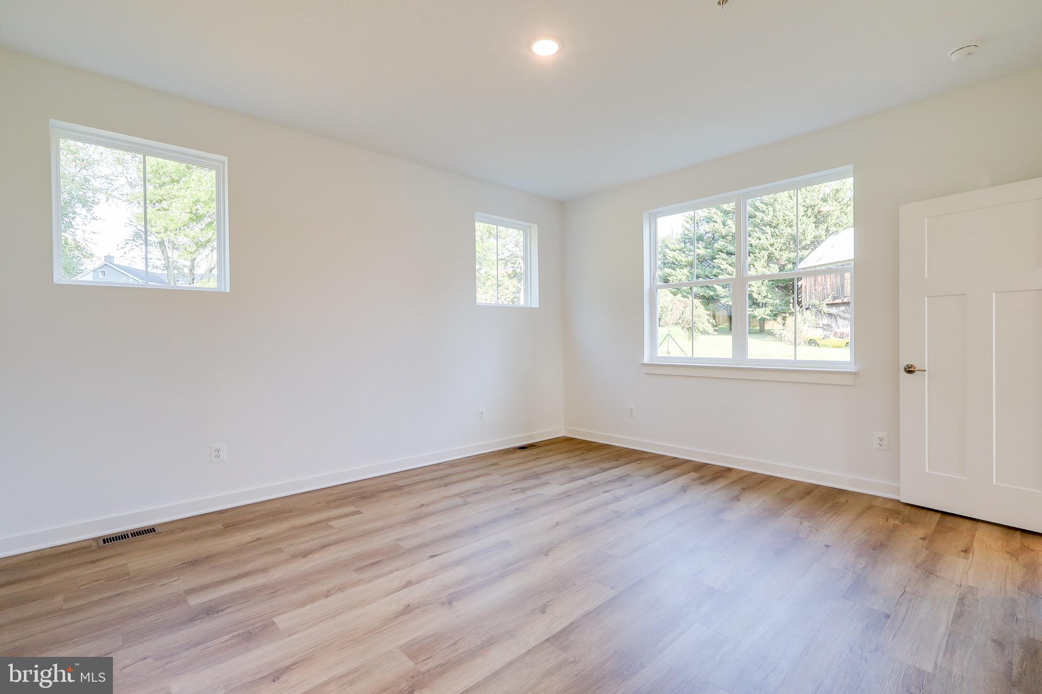 14 Stouffer Avenue Boonsboro, MD 21713 - Photo 18 of 40 a view of an empty room with wooden floor and a window