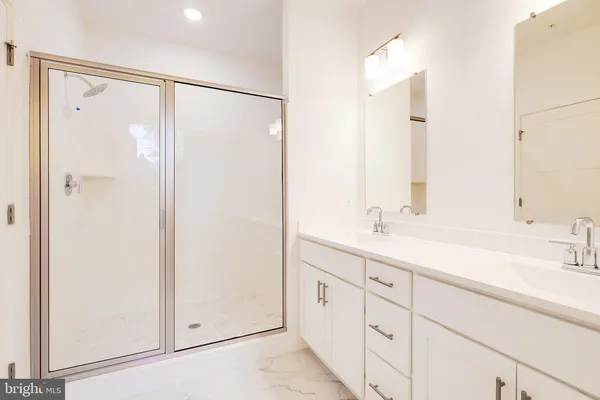 a bathroom with a shower sink and vanity