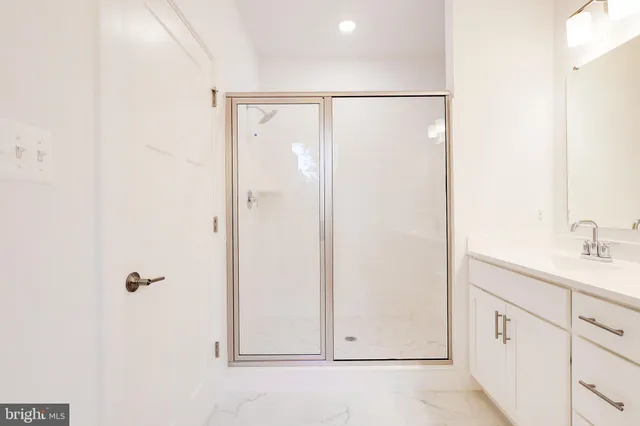 a bathroom with a double vanity sink a mirror and next to a window