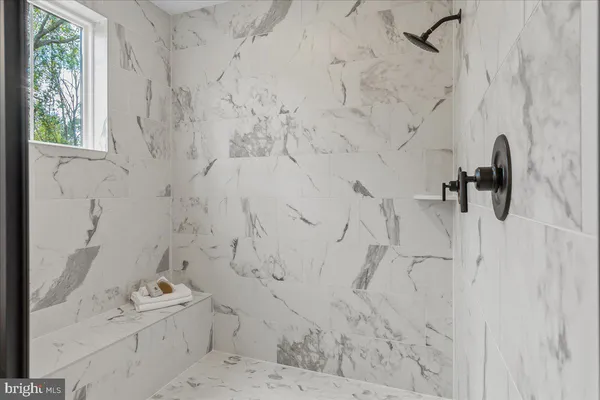 a bathroom with a shower sink and mirror