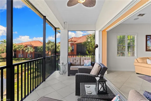 a balcony with furniture and large windows