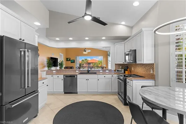 a kitchen with granite countertop stainless steel appliances a sink and counter space
