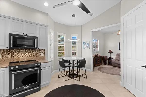a kitchen with stainless steel appliances kitchen island granite countertop a stove a sink and a microwave