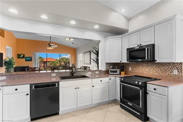 a kitchen with stainless steel appliances granite countertop a sink and cabinets