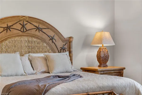 a bedroom with a bed and lamp