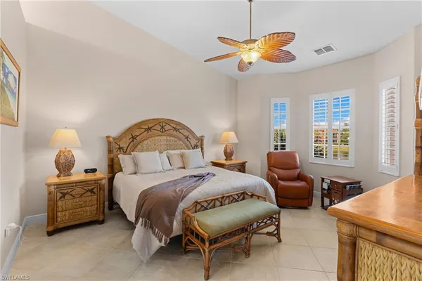 a bedroom with two beds and a chandelier