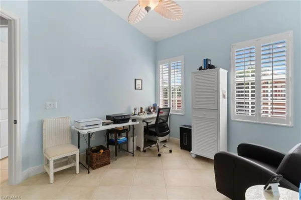 a view of a workspace with furniture and a window