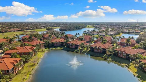 an aerial view of a city with lots of residential buildings lake and ocean view