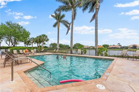 a view of swimming pool with a table and chairs